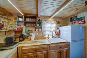 a kitchen with a white refrigerator and wooden cabinets at Tiny House Leadville Colorado in Leadville