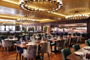 a restaurant with tables and chairs and a bar at The Grand, York in York