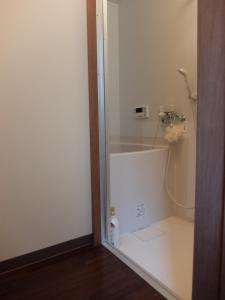 a bathroom with a shower and a toilet in a room at Guesthouse Engawa in Kyoto