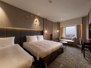 Кровать или кровати в номере The Howard Prince Hotel Taichung