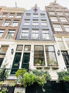 a building with windows and plants in front of it at Aris Amsterdam in Amsterdam