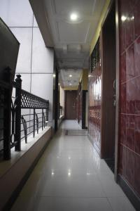 an empty hallway in a building with a hallway at Hotel Sai Vishwa in Shirdi