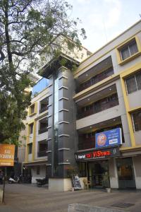 a building with a sign in front of it at Hotel Sai Vishwa in Shirdi