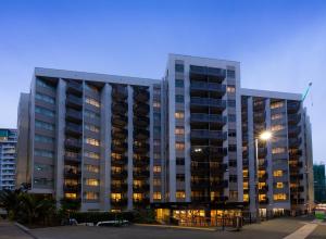 a tall building with a street light in front of it at Nesuto Stadium in Auckland