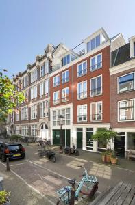 two bikes parked on a street in front of buildings at Boutique Studio Magielsen in Amsterdam