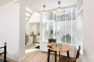 a dining room with a table and a large window at Boutique Studio Magielsen in Amsterdam