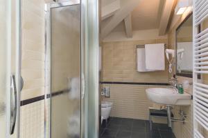 a bathroom with a sink and a toilet at Hotel Residence La Luna Nel Porto in Stresa