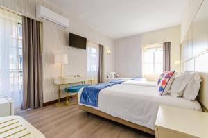 a hotel room with a large bed and a desk at Hotel LX Rossio in Lisbon