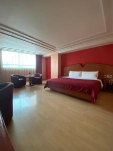 a hotel room with a bed and a red wall at HOTEL MARIA RICO in Mexico City