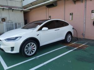 a white car is parked in a parking lot at Kending Kaying Hotel in Hengchun South Gate