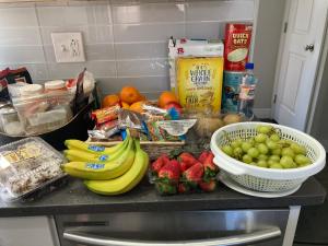 a kitchen counter with a bunch of fruits and vegetables at Luxury Rooms near Temple U, Drexel, UPenn, and the MET in Philadelphia