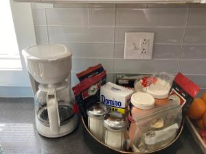 a kitchen counter with a coffee maker and some food at Luxury Rooms near Temple U, Drexel, UPenn, and the MET in Philadelphia