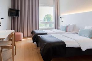 A bed or beds in a room at Scandic Helsinki Aviapolis