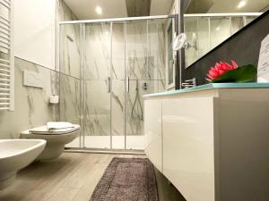 a bathroom with a shower and a toilet and a sink at Blue House Varenna in Varenna