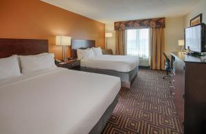 a hotel room with two beds and a flat screen tv at Holiday Inn Knoxville West - Cedar Bluff, an IHG Hotel in Knoxville