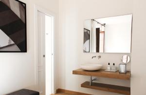 a bathroom with a sink and a mirror at La Ermita Suites - Único Hotel Monumento de Córdoba in Córdoba