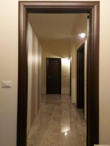 a hallway with a mirror and a black door at Arte Mia B&B in Reggio di Calabria