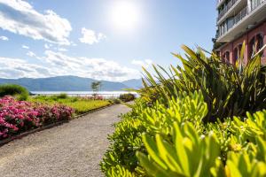 a walk way with flowers and a building at Hotel de Charme Laveno in Laveno-Mombello