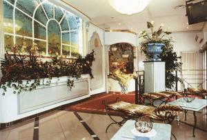 a room with a large window with plants on the wall at Hotel La Bussola in Cittiglio