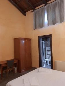 a bedroom with a bed and a cabinet and a window at Palazzo Marzano in Briatico