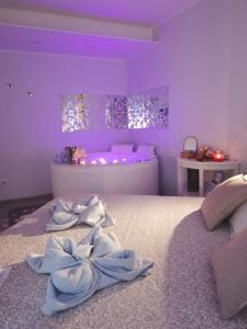 a purple room with two towels on a bed at Blue House Varenna in Varenna