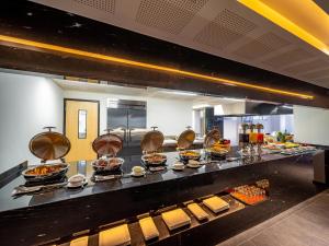 a buffet line with many plates of food at Galeria Plaza San Jeronimo in Mexico City