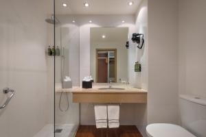 a bathroom with a sink and a shower at Melia Lisboa Oriente Hotel in Lisbon