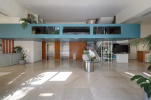 a large lobby with a blue ceiling at Melia Lisboa Oriente Hotel in Lisbon