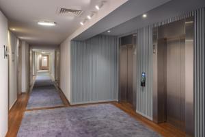 a corridor of an office building with a hallway at Melia Lisboa Oriente Hotel in Lisbon