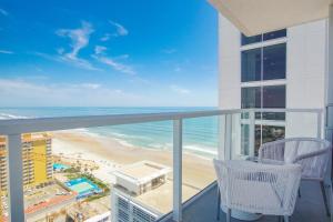 a balcony with chairs and a view of the beach at Daytona Grande Oceanfront Resort in Daytona Beach