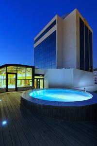 a large swimming pool in front of a building at Turia Granada in Granada