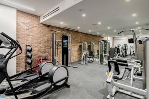 a gym with treadmills and machines in a brick wall at EXchange Hotel Vancouver in Vancouver