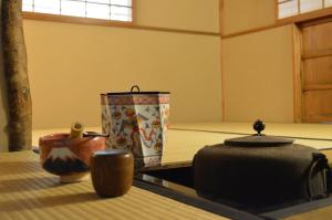 a group of containers sitting on a table in a room at Yadoya Manjiro in Kyoto