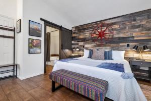 a bedroom with a large bed and a wooden wall at Red Rock Inn Cottages in Springdale