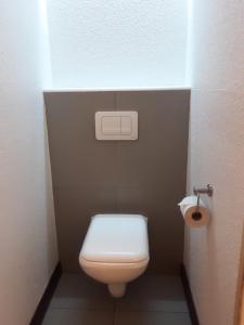 a small bathroom with a toilet and a toilet paper dispenser at SUN1 Durban in Durban