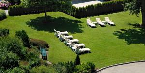 a group of lawn chairs sitting in the grass at Hotel Bräu in Zell am Ziller