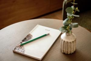 uma caneta sentada em cima de um caderno sobre uma mesa em Wilde Aparthotels London Paddington em Londres