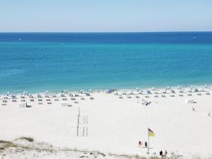 a beach with a lot of umbrellas and the ocean at Perdido Beach Resort in Orange Beach