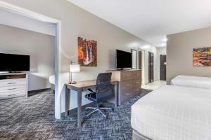 a hotel room with a desk with a bed and a computer at Best Western Plus Zion Canyon Inn & Suites in Springdale