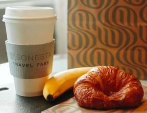 a croissant and a banana and a cup of coffee at Sonesta ES Suites Dallas Medical Market Center in Dallas