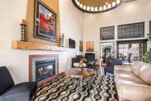 a living room with a couch and a fireplace at Clarion Suites St George - Convention Center Area in St. George