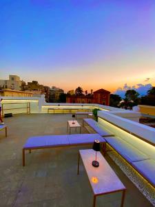 a group of benches sitting on top of a roof at PALAZZO FIACCADORI - Historical Palace in Reggio di Calabria