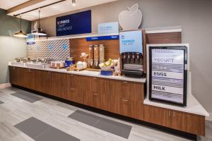 Holiday Inn Express & Suites - Miramar, an IHG Hotel في ميرامار: an apple store with a counter with an applerateryasteryasteryasteryasteryasteryastry