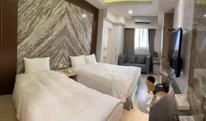 Кровать или кровати в номере Hotel Maple Taiwan Boulevard