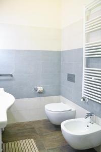 a bathroom with a white toilet and a sink at Xenia Home in Reggio di Calabria