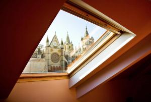 a window with a view of a castle at Hotel Spa QH Centro León in León