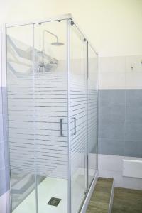 a glass shower in a bathroom with a sink at Xenia Home in Reggio di Calabria