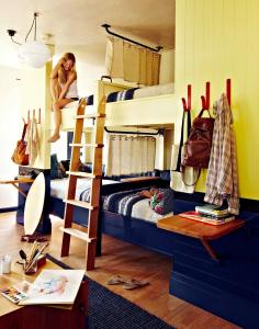 a woman is sitting on top of bunk beds at Freehand Miami in Miami Beach