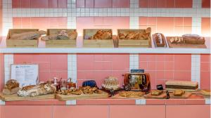 a shelf with different types of bread and pastries at Hôtel Tandem - Boutique Hôtel in Strasbourg