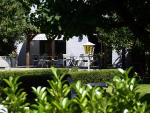 a view of a garden with a table and chairs at Hotel Les Terrasses in Annecy